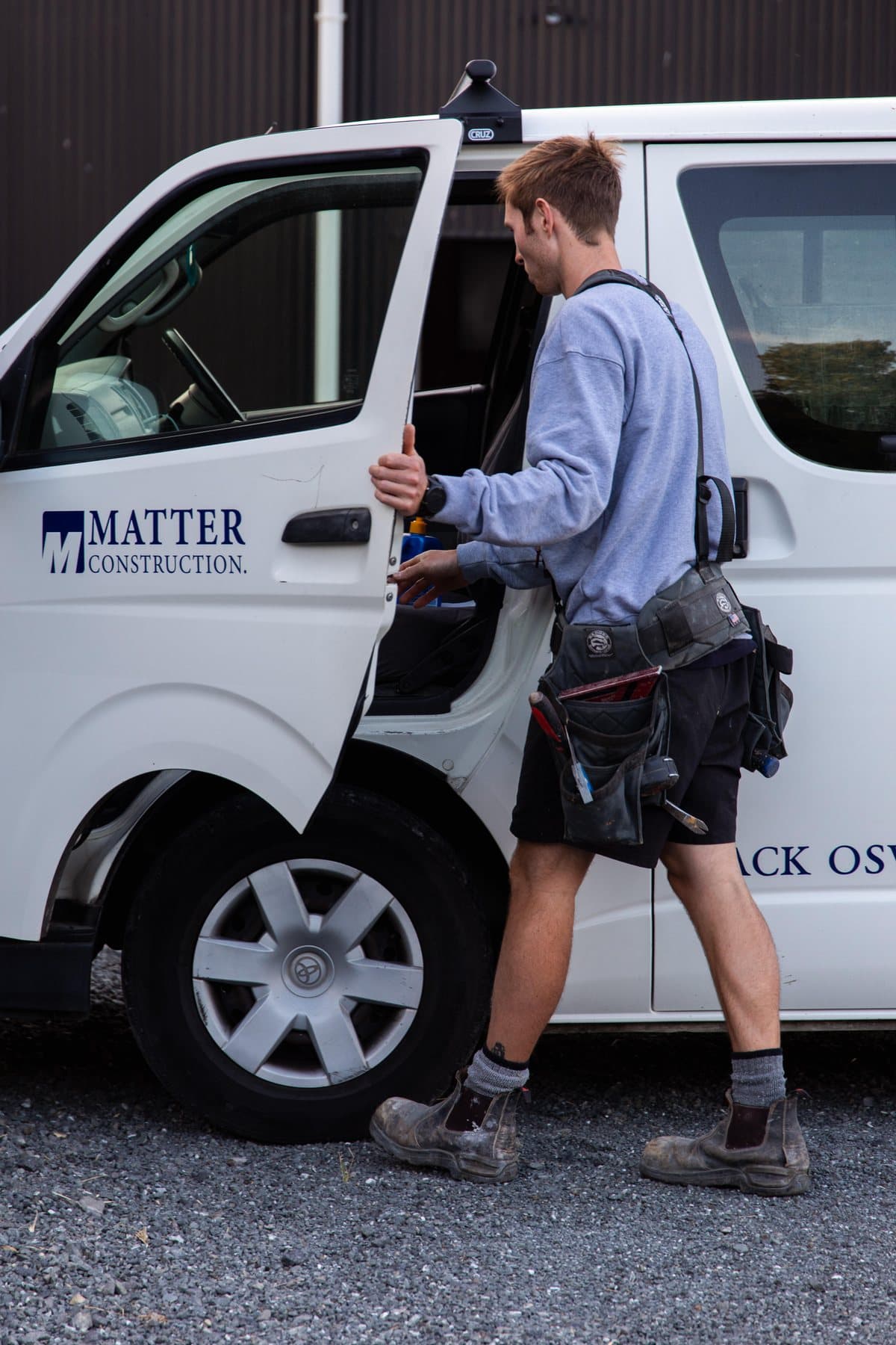 A Matter Construction team member hopping into the branded work van, ready for the next job